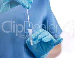 Unrecognizable doctor wearing gloves and holding a cotton swab while standing against a white studio background. Unrecognizable gp preparing to use a cotton swab at a hospital