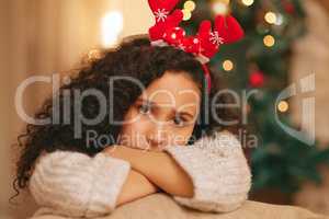 Nothing happy about my holidays. a young woman feeling unhappy during Christmas at home.