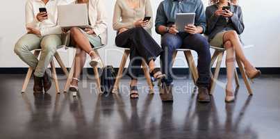 The best recruit for the best company. Shot of a group of businesspeople waiting in a line in a modern office.