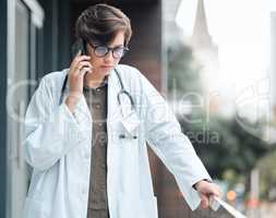 Shes always ready to lend a listening ear. a young female doctor on a call against a city background.