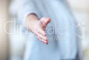 An honour to meet you. Shot of an unrecognisable businesswoman reaching out to shake hands in a modern office.