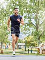 Boost your day with a morning jog. Shot of a sporty young man running outdoors.