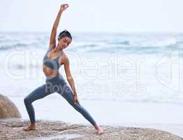 Yoga is a way of life. Full length shot of an attractive young woman practicing yoga on the beach.