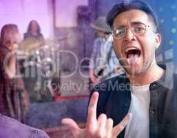 Rock on. Cropped portrait of a handsome young male rocker performing on stage with his bandmates in the background.