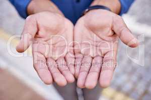 Be kind, stay humble. Closeup shot of an unrecognizable businessman standing with his hands cupped together.