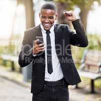 Yes I got the job. a handsome young businessman cheering at his cellphone during his morning commute into work.