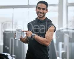 Portrait of smiling asian trainer alone in gym showing cellphone screen. Coach standing, promoting discount and deal for workout in health club. Young confident man tracking exercise in fitness centre