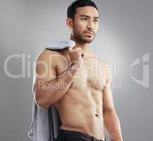 She swears she saw me in her dreams again. Studio shot of a muscular young man posing against a grey background.