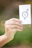 A feminist is anyone who recognizes the equality. Shot of a unrecognizable woman holding a card in protest in a park.