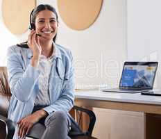 One of our trained agents will take your call. a woman wearing a headset while sitting at her desk.