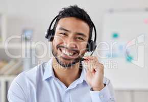 Portrait Face of happy mixed race call centre telemarketing agent with big smile talking on headset while working in office. Confident friendly businessman operating helpdesk for customer service sales support