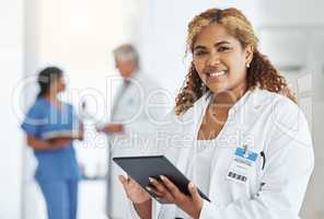 Being organised is essential to getting tasks done. Portrait of a young doctor using a digital tablet in a hospital.
