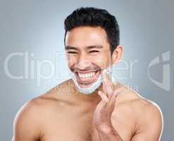 Lather up to help protect your skin against irritation. Studio shot of a man applying shaving foam to his face.