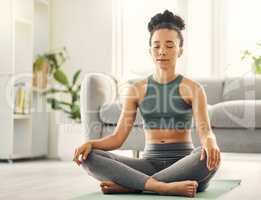 If you dont meditate then youre missing out on peace. a young woman practising yoga in her living room.