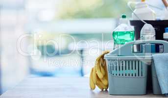 Empty basket of cleaning products with yellow gloves on the floor. Bucket of collection of cleaning supplies and chemicals on the floor. Professional hygiene cleaning products oh the floor of a home