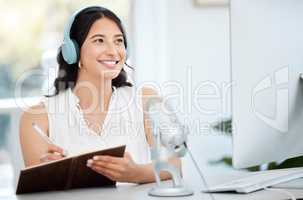 Our lineup today is jam-packed with riveting news. Shot of a young woman writing notes during a broadcast in an office.