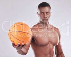 Ill show you how to shoot hoops. Studio portrait of a muscular young man posing with a basketball against a grey background.
