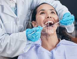 The perfect smile is easily achievable. Shot of a young woman having a procedure performed by her dentist.