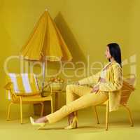 They call me mellow yellow. Studio shot of a young woman dressed in stylish yellow clothes against a yellow background.