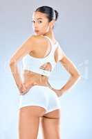 Testosterone driven fever. Portrait of an attractive young woman looking over her shoulder while posing in her underwear in the studio.