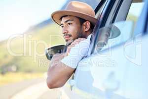 All he needed was a wheel in his hand. Shot of a young man enjoying an adventurous ride in a car.