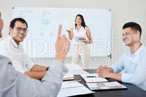 She always welcomes further suggestions. Shot of a young businesswoman leading a meeting with her colleagues in an office.