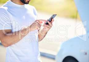 Somebody come and get me. Shot of a unrecognizable man on the phone with roadside assistance after suffering a vehicle breakdown.