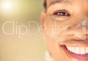 Closeup portrait of a beautiful young African American woman face. Smiling black female showing her healthy teeth and perfect dental and oral hygiene while outside in the city enjoying fresh air.