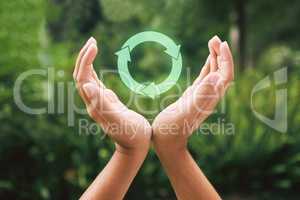Hands supporting a digital recycle symbol. Someone protecting the environment through recycling. Technology is the future of sustainability