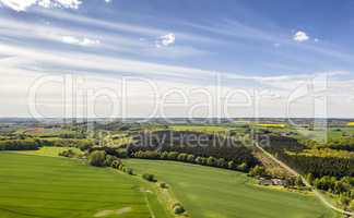Countryside with natural, green and sunny field on farm. Calm, beautiful and large agriculture space. Clear blue skies and soft grass during the spring daytime. Area found in Jutland, Denmark