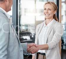 The best partnerships start with a handshake. Shot of two businesspeople shaking hands in an office at work.