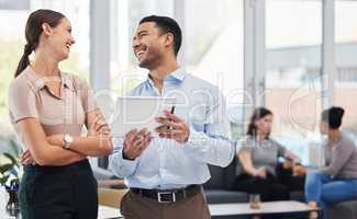 Id like your input on this. a businessman and businesswoman talking while using a digital tablet.