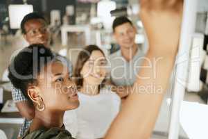 African american business woman leader coach mentor writing on board planning strategy while brainstorming with colleagues. Diverse colleagues discussing ideas while collaborating on project