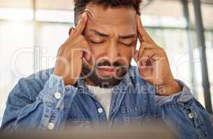 Young man looking stressed with a headache at home. Man feeling anxious with a migraine at home. Depressed young man with a headache at home. bachelor having a breakdown crisis at home