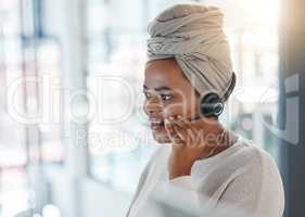 One happy african american call centre telemarketing agent talking on a headset while working in an office. Confident friendly female consultant operating a helpdesk for customer service and sales support