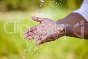 Save every little drop. an unrecognizable person washing their hands in nature.