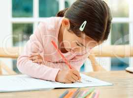 Focusing on her homework. Cropped shot of an adorable little girl doing her homework.