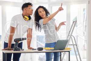 From concept to planning. Shot of a young couple using a laptop while busy renovating a house.