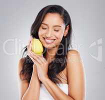 For longer, stronger hair. Cropped shot of an attractive young woman posing with a lemon against a grey background.