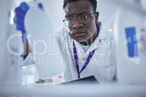 Ah hes found it. Shot of a young male scientist looking for a product in his lab.