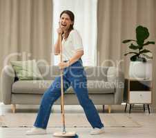 Fun was had. a young woman singing while sweeping the floors at home.