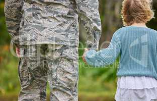 Love, honesty, and connection are cultivated in a family. Shot of a unrecognizable man holding his daughters hand outside.