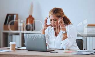 Stressed African American businesswoman making a mistake while using her laptop in the office. Professional black woman feeling pressured while using technology. Creative entrepreneur with a headache