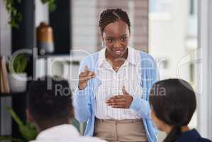 There has never been a better time to strive for this. a young businesswoman having a meeting with her staff.