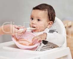 Perfection only exists in babies and pastries. a baby being fed at home.