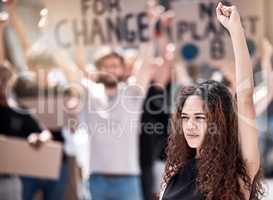 Putting their power to good use. Shot of a young female protestor leading the charge during a rally.