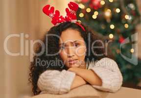 Christmas aint what it used to be. a young woman feeling unhappy during Christmas at home.