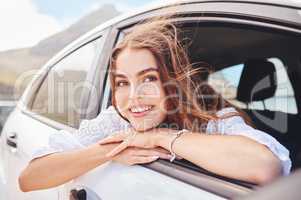 What could be better than traveling. a beautiful young woman enjoying an adventurous ride in a car.