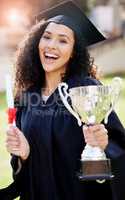 She truly deserves the title of Top Achiever. Portrait of a young woman holding a trophy and cheering on graduation day.