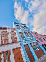 Colorful buildings in the streets of Santa Cruz de La Palma. Houses or homes built in a vintage architecture design in a small town or village. Vibrant city with cloudy blue sky and copyspace